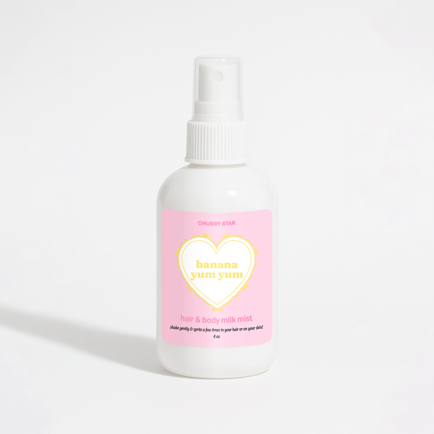 A white plastic spray bottle of Chubby Star Banana Yum Yum hair & body milk mist with a pink label, set against a clean white background.