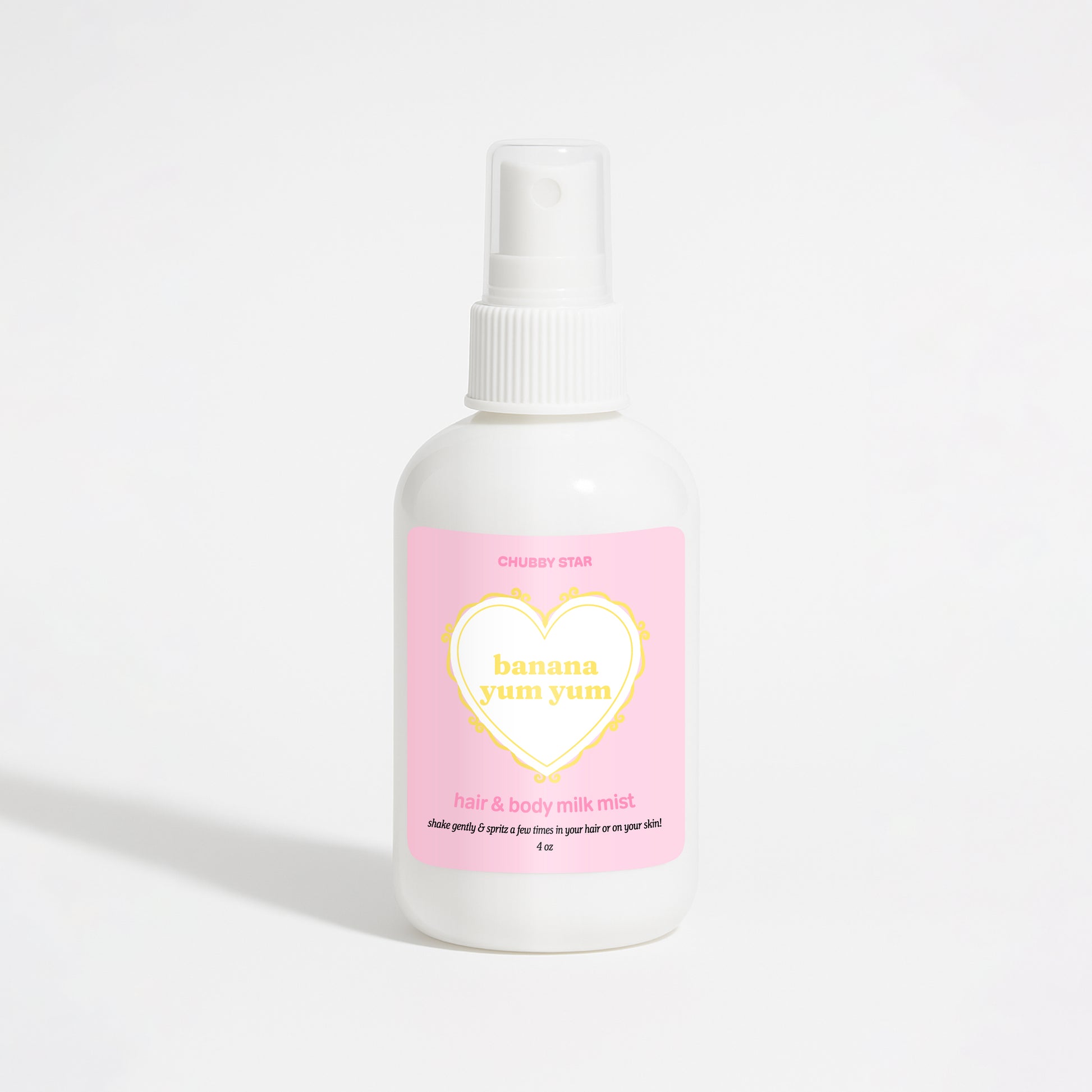 A white plastic spray bottle of Chubby Star Banana Yum Yum hair & body milk mist with a pink label, set against a clean white background.
