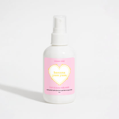 A white plastic spray bottle of Chubby Star Banana Yum Yum hair & body milk mist with a pink label, set against a clean white background.