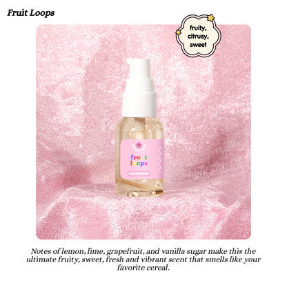 Fruit Loops-themed body oil bottle on a pink background with product description text.