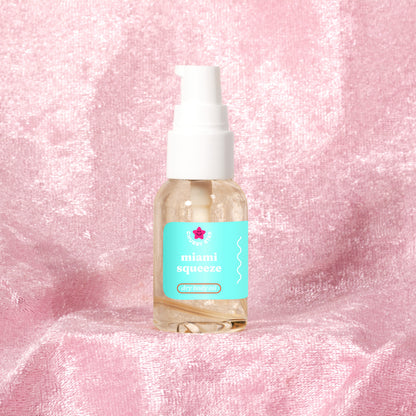 Miami Squeeze, a Miami Nectar dupe, scented 1 oz body oil mini on a pink background 