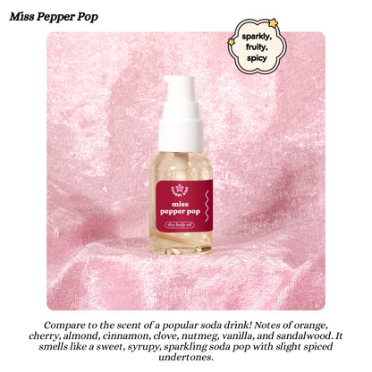 Miss Pepper Pop dr pepper scented dry body oil bottle on a pink textured background