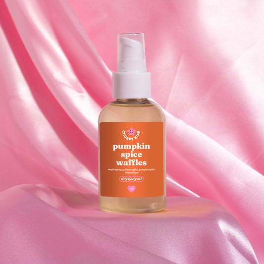 pumpkin spice waffles scented body oil sitting on pink satin fabric, made by chubby star, a small women owned business in the usa. perfect for fall scent