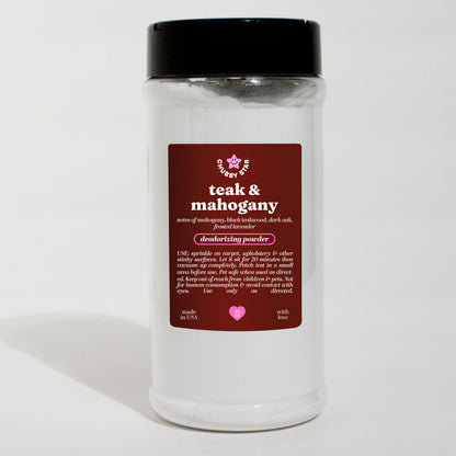 A  plastic jar of 'teak & mahogany' scented deodorizing powder with a black lid and a dark brown label, set against a plain white background.