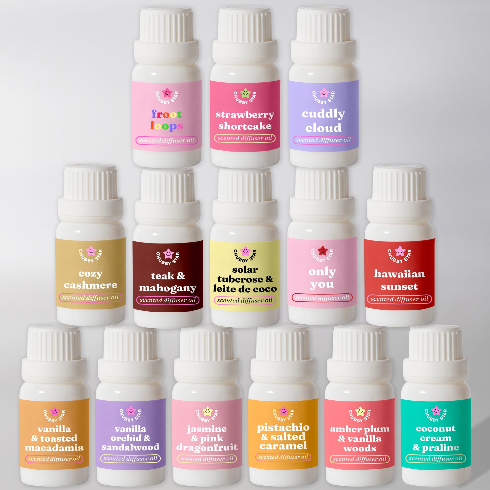 viral tiktok diffuser oil bottles stacked on a plain grey background