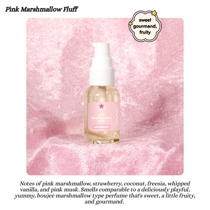 pink marshmallow fluff scent dry body oil bottle with pink label on a pink textured background
